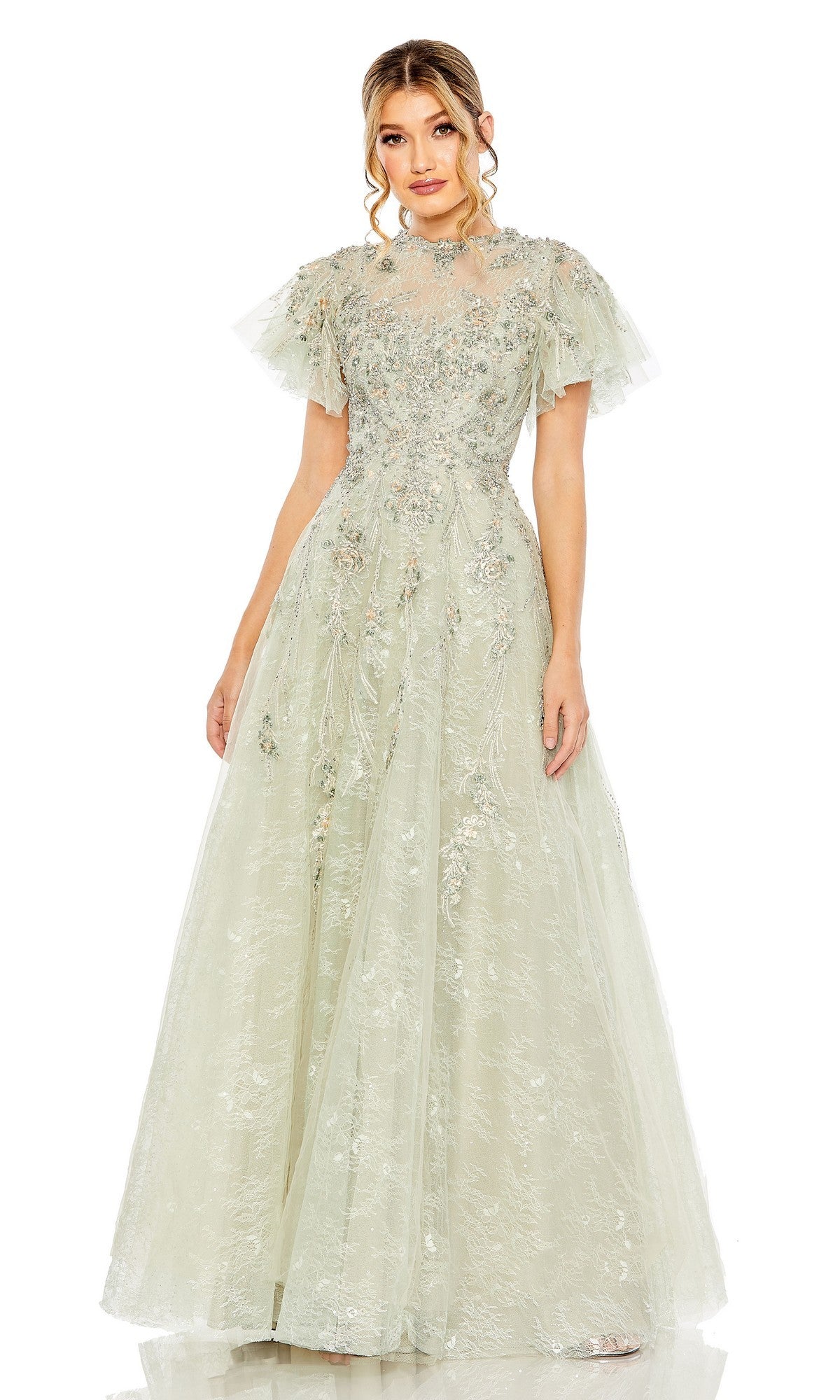 A woman stands facing forward in a seafoam Mac Duggal 20450 long formal dress featuring embroidery, floral embellishments, and short tulle sleeves.
